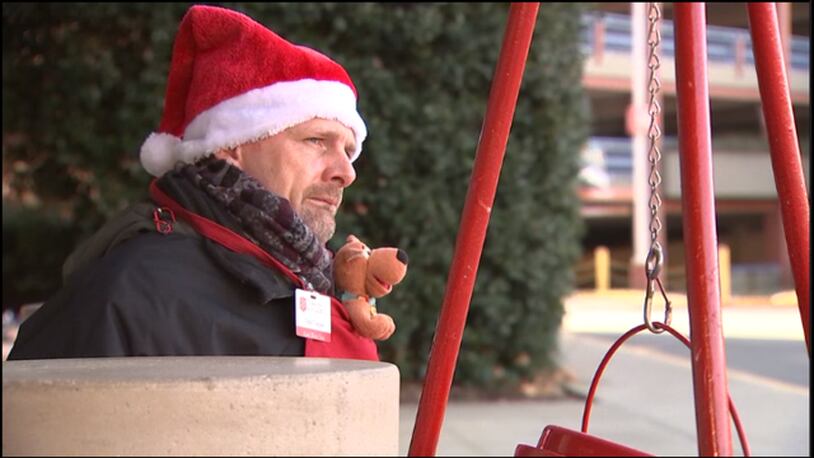 Police say a boy stole a Salvation Army kettle from Todd Cooper (pictured) while he was manning his post at an Atlanta mall.
