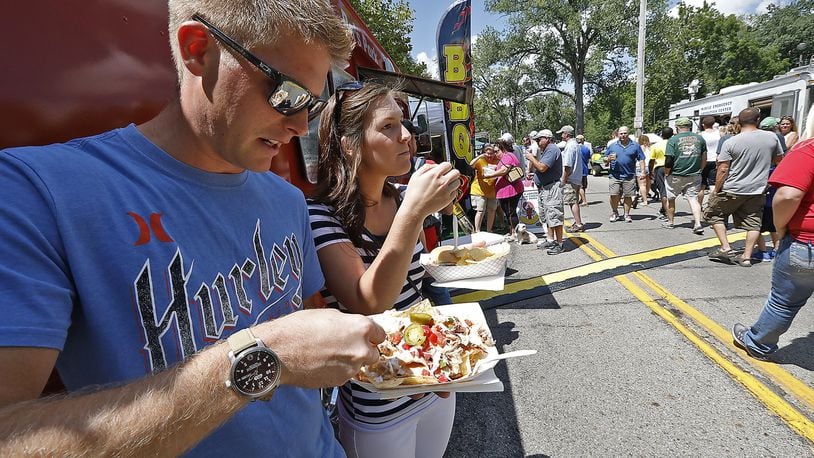 Chase and Della Rice enjoy nachoes from a BBQ food truck at the Springfield Rotory Food Truck Competition at Veteran’s Park earlier this year. The fourth annual Local Food Summit will be held Nov. 4. Bill Lackey/Staff