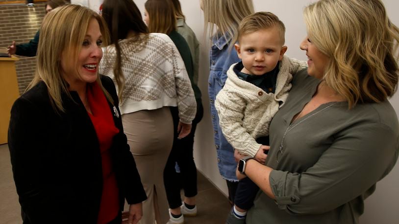 Clark State President Jo Alice Blondin talks to Alyssa Jennings and her son, Maverick, before the graduation ceremony for Alyssa and the other students in the Diagnostic Medical Sonography program Friday, Dec. 8, 2023. BILL LACKEY/STAFF
