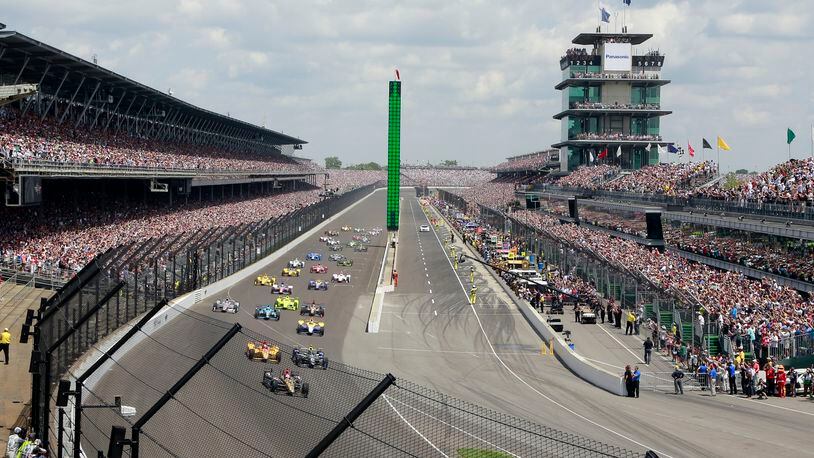 FILE - In this May 29, 2016, file photo, James Hinchcliffe, of Canada, leads the field into the first turn on the start of the 100th running of the Indianapolis 500 auto race at Indianapolis Motor Speedway in Indianapolis. Indianapolis Motor Speedway president Doug Boles had a very real fear following last year’s 100th edition of the Indy 500: That many in the record-setting crowd packing his track last May would decide to be “101 and done.” Instead, the milestone appears to have given the Greatest Spectacle in Racing a lasting bump heading into next weekend’s running. (AP Photo/R Brent Smith, File)