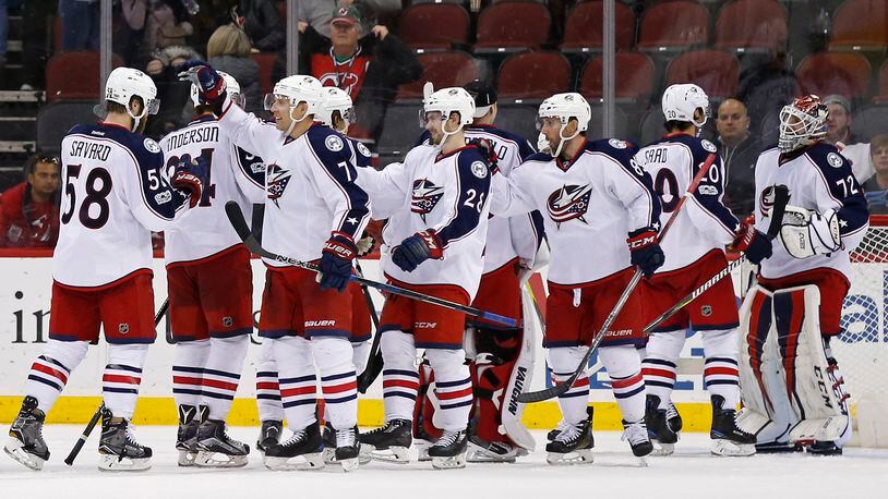 Columbus Blue Jackets goalie Sergei Bobrovsky (72) celebrates with teammates after defeating the New Jersey Devils 4-1 in an NHL hockey game, Sunday, March 19, 2017, in Newark, N.J. The Blue Jackets clinched a playoff spot with the win. (AP Photo/Adam Hunger)