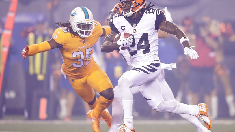 Walt Aikens of the Dolphins tries to to tackle Bengals cornerback Adam Jones during a Sept. 29, 2016 game at Paul Brown Stadium.