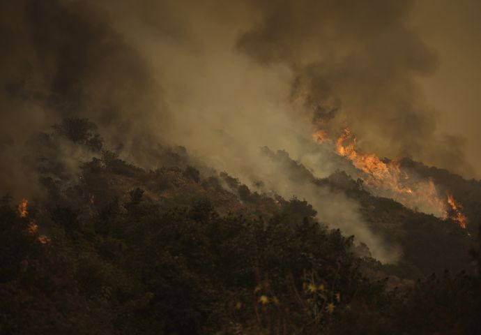 Acrid smoke and flames from the Bobcat Fire on a slope thick with vegetation in Santa Anita Canyon near Los Angeles, Sept. 13, 2020. President Donald Trump visited California after weeks of silence on its wildfires and blamed the crisis only on poor forest management, not climate change. (Eric Thayer/The New York Times)