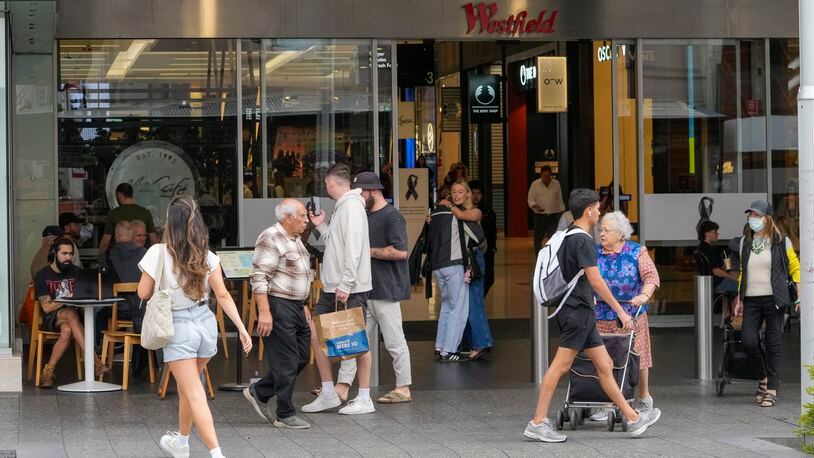 People walk outside the Westfield shopping mall at Bondi Junction in Sydney, Friday, April 19, 2024. The Sydney shopping mall reopened for business on Friday for the first time since it became the scene of a mass stabbing in which six people died on Saturday, April 13. (AP Photo/Mark Baker)