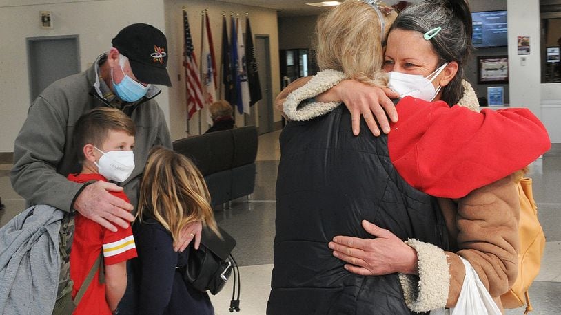 The holidays are for time with family and traveling. Tom and Barbara Macleod hug their daughter Emily Macleod and grandchildern Bo and Etta Macleod Haynie, after they arrived at the Dayton International Airport Monday, Dec. 20, 2021. MARSHALL GORBY\STAFF
