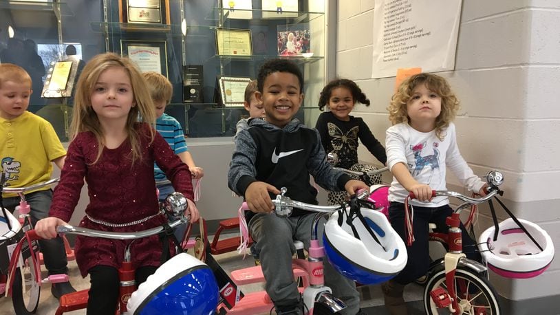 Clark Early Learning Center preschool students, from left, April Scott, Jayon McWhorter, Kyleigh Richard and Trinity Miller enjoy new tricycles donated to the school by PNC Bank in 2017. Brett Turner/Contributed