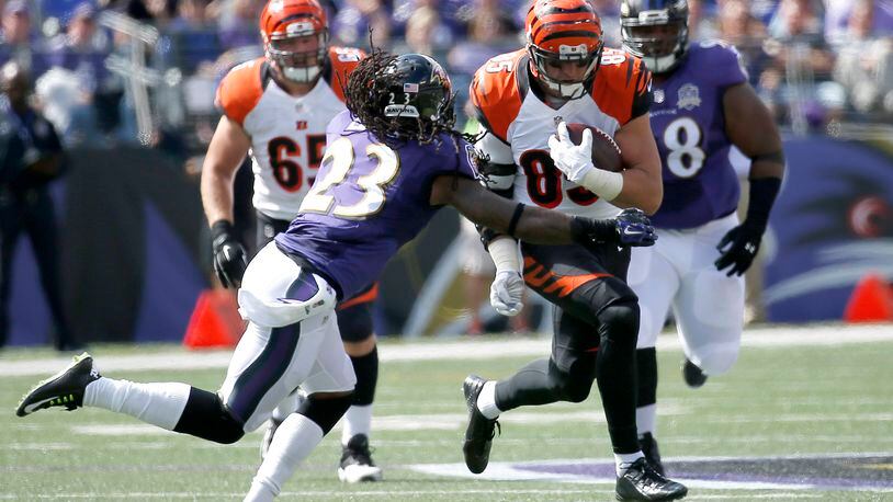 BALTIMORE, MD - SEPTEMBER 27: Tight end Tyler Eifert #85 of the Cincinnati Bengals carries the ball while free safety Kendrick Lewis #23 of the Baltimore Ravens defends in the second quarter of a game at M&T Bank Stadium on September 27, 2015 in Baltimore, Maryland. (Photo by Rob Carr/Getty Images)