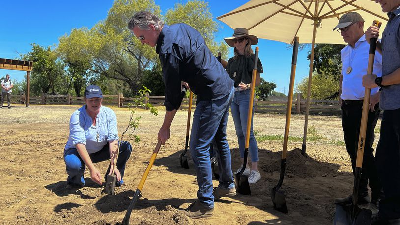 California Gov. Gavin Newsom breaks ground at a new state park in a decade on Monday April 22, 2024 at the Dos Rios property, in Modesto, Calif. The announcement comes as the state sets targets for cutting planet-warming emissions on natural lands. (AP Photo/Sophie Austin)