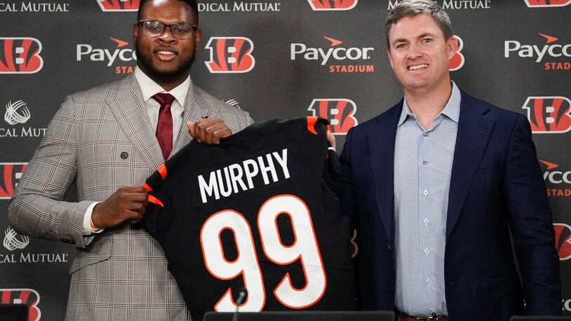 Clemson defensive end Miles Murphy, left, the Cincinnati Bengals' first-round draft pick, poses for a portrait with Cincinnati Bengals head coach Zac Taylor, right, during a news conference, Saturday, April 29, 2023, in Cincinnati. (AP Photo/Joshua A. Bickel)