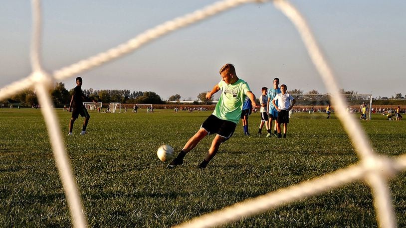 Xane Grigsby kicks a goal during soccer practice Tuesday evening at the Eagle City Soccer Complex. Bill Lackey/Staff
