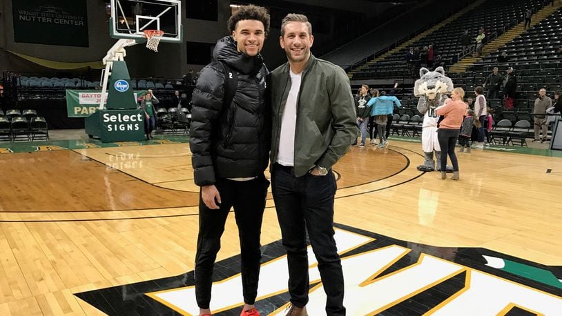 Wright State freshman Tanner Holden (left) and former Raiders standout, Dr. Drew Burleson after Saturday night’s game at the Nutter Center. Tom Archdeacon/CONTRIBUTED