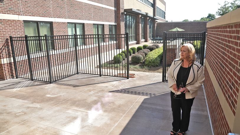 Kelly Rigger, CEO of Springfield Mental Health Services, looks over a new outdoor space that's been constructed with the new addition Thursday, August 18, 2022. BILL LACKEY/STAFF