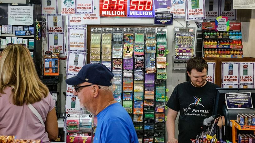 Bee-Gee's Mini Mart customer service expert, Quentin DeVelvis, right, has been printing-out Powerball tickets Thursday morning July 13, 2023. The Powerball is an estimated $875 million ahead of Saturday's drawing. JIM NOELKER/STAFF