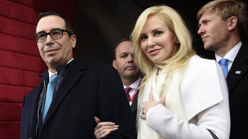 In this Friday, Jan. 20, 2017, file photo, then Treasury Secretary-designate Stephen Mnuchin and his then-fiancee, Louise Linton, arrive on Capitol Hill in Washington, for the presidential inauguration of Donald Trump. Linton responded to a social media critic on Aug. 21, 2017, telling the mother of three that that she was âadorably out of touch.â Mnuchin and Linton were married in June. (Saul Loeb/Pool Photo via AP, File)