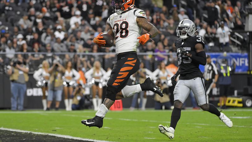 Cincinnati Bengals running back Joe Mixon (28) scores a touchdown against the Las Vegas Raiders during the second half of an NFL football game, Sunday, Nov. 21, 2021, in Las Vegas. (AP Photo/David Becker)