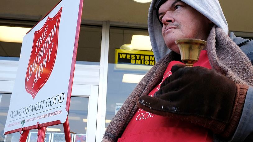 Joseph Pash rings a bell outside a grocery store as he collects money for the Salvation Army in Springfield. Bill Lackey/Staff