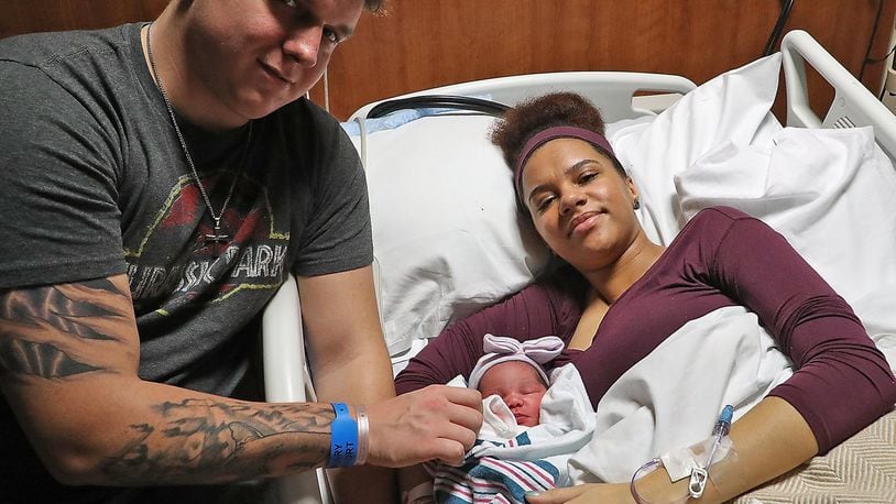 Austin Pratt, 24, and Brianna Miller, 24, with their new baby girl, Ellamae Rose Pratt. Ellamae is the first baby born in Clark County this year, arriving at 5:35 pm. BILL LACKEY/STAFF