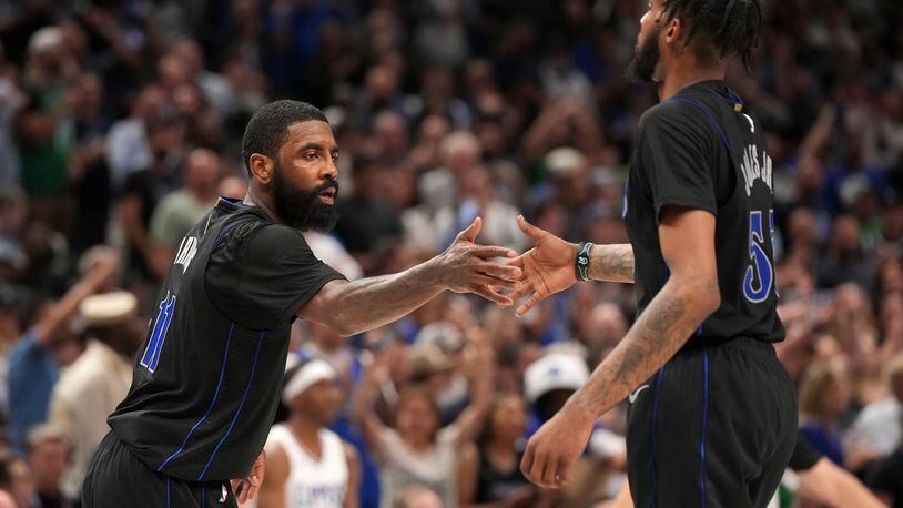 Dallas Mavericks guard Kyrie Irving (11) congratulates forward Derrick Jones Jr. (55) during the second half of an NBA basketball first-round playoff series against the Los Angeles Clippers Friday, May 3, 2024, in Dallas. (AP Photo/Jeffrey McWhorter)
