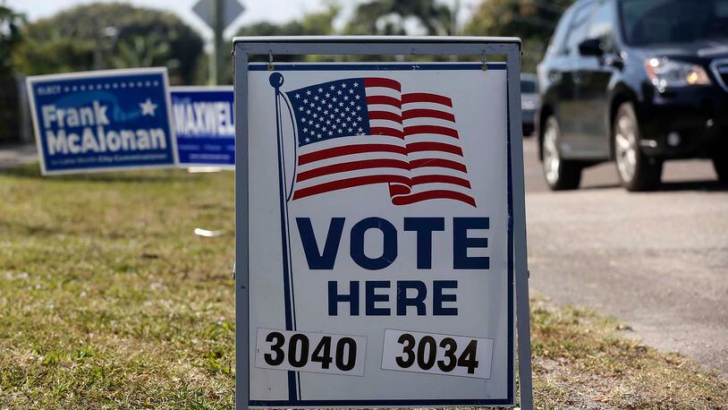 A “Vote Here” sign directs voters to the polling location for Precincts 3040 and 3034 at the Scottish Rite Masonic Center in Lake Worth Tuesday, March 15, 2016. (Bruce R. Bennett / The Palm Beach Post)