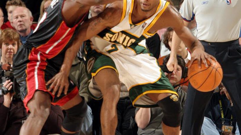 Rashard Lewis #7 of the Seattle SuperSonics looks to play the ball against Dwyane Wade #3 of the Miami Heat on January 9, 2005 at Key Arena in Seattle, Washington.  (Photo by Otto Greule/Getty Images)