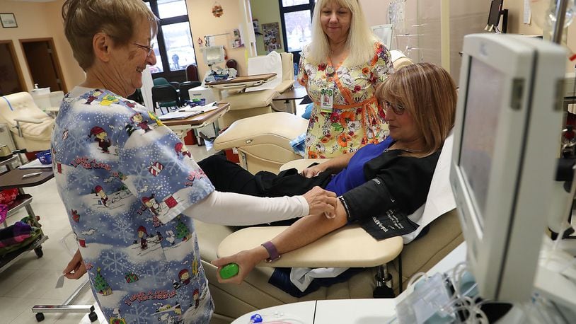 Kelly Skelton talks with Beryl Boggess, left, and Theresa Burns as she gets ready to donate blood at the Community Blood Center in December. The Blood Center closed at the end of the year. BILL LACKEY/STAFF