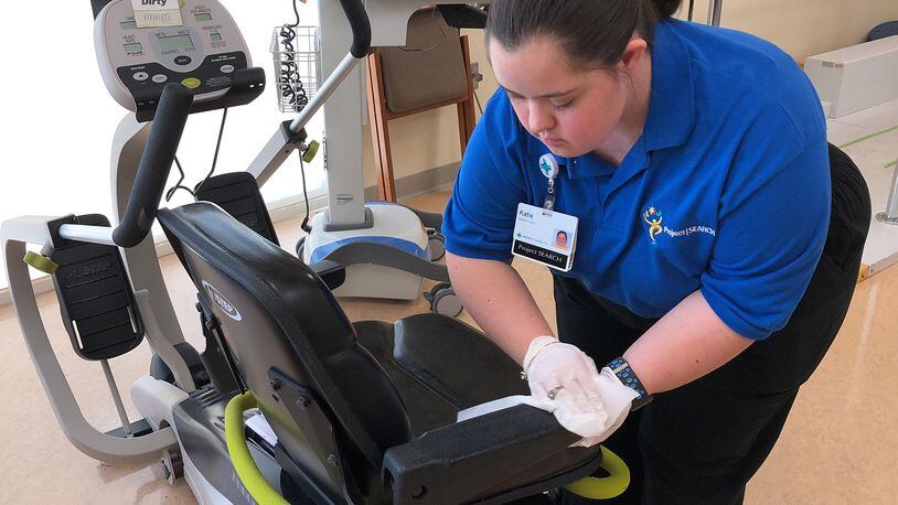 Katie Terry, one of the students in the Project SEARCH program at Springfield Regional Medical Center, cleans the equipment in the Rehab Center at the hospital Wednesday, April 4, 2018. Bill Lackey/Staff