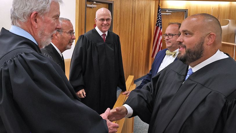 Brian Driscoll, right, shakes hands with other Clark County judges after being sworn in as a Municipal Court Judge in the file photo. BILL LACKEY/STAFF
