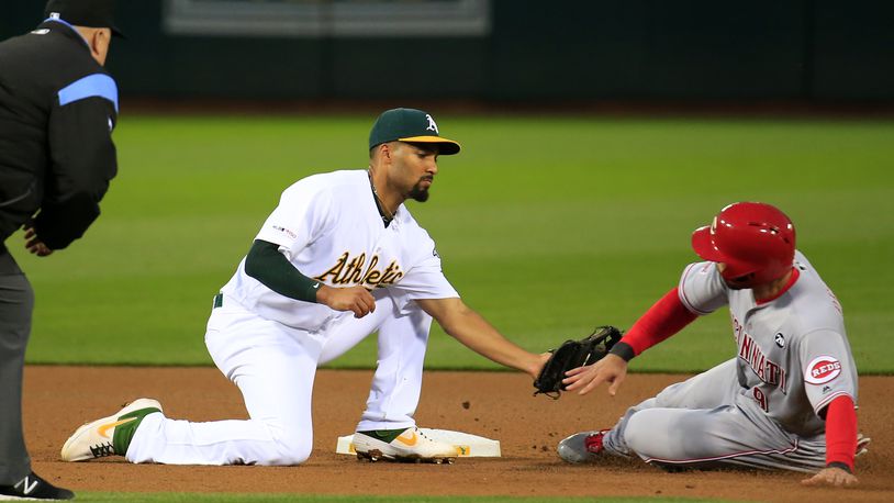 OAKLAND, CALIFORNIA - MAY 08: Marcus Semien #10 of the Oakland Athletics tags out Jose Peraza #9 of the Cincinnati Reds during the fourth inning at Oakland-Alameda County Coliseum on May 08, 2019 in Oakland, California. (Photo by Daniel Shirey/Getty Images)