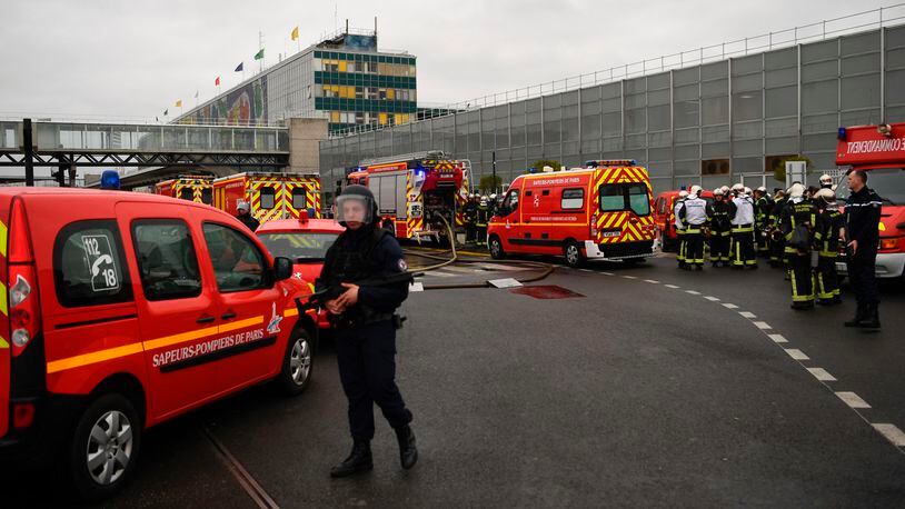 French policemen and firefighters secure the area at Paris' Orly airport on Saturday following the shooting of a man by French security forces.
Security forces at Paris' Orly airport shot dead a man who took a weapon from a soldier, the interior ministry said. Witnesses said the airport was evacuated following the shooting at around 8:30am (0730GMT). The man fled into a shop at the airport before he was shot dead, an interior ministry spokesman told AFP. He said no people were wounded in the incident.