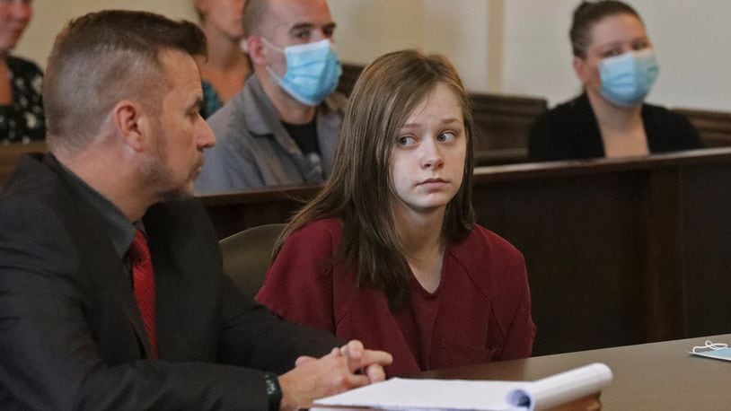 Natasha Ellis, 16, looks at her lawyer before pleading guilty Thursday to the murder and attempted murder of her friend’s parents in New Carlisle last year. BILL LACKEY/STAFF