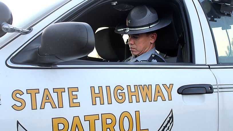 Ohio State Highway Patrol trooper Jason Hodge of the Springfield Post writes up a report in his patrol car. Jeff Guerini/Staff