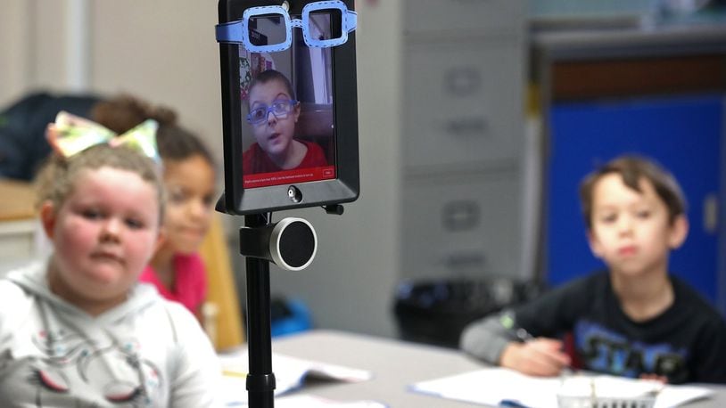 Thanks to a robot designed by the Ohio State University engineering department, Levi Suttles, 6, is still able to attend school at Miami View School in South Charleston despite battling leukemia. The robot allows Levi to move around and interact with his class from a computer at home. BILL LACKEY/STAFF