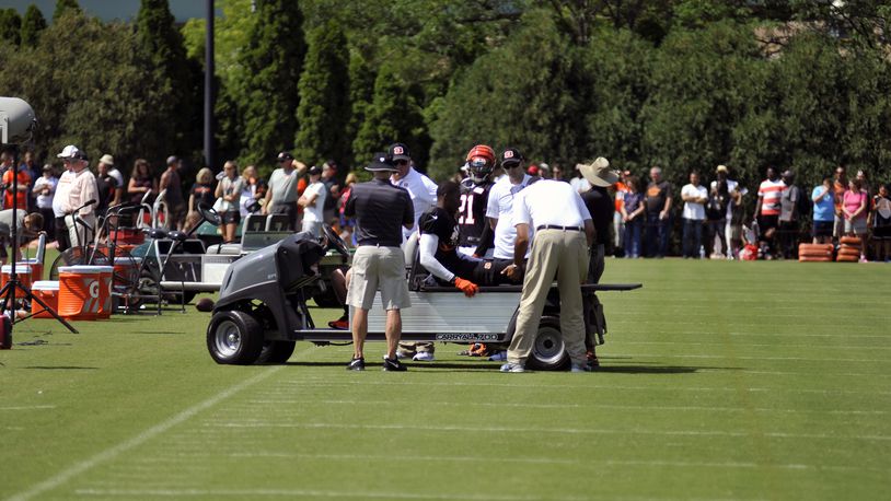Trainers look at safety George Iloka’s right knee after he injured it during Sunday’s practice. JAY MORRISON/STAFF