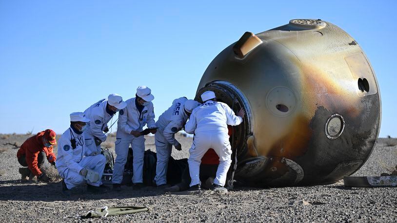 In this photo released by Xinhua News Agency, workers open up the capsule of the Shenzhou-17 manned spaceship after it lands successfully at the Dongfeng landing site in north China's Inner Mongolia Autonomous Region, Tuesday, April 30, 2024. China's Shenzhou-17 spacecraft returned to Earth Tuesday, carrying three astronauts who have completed a six-month mission aboard the country's orbiting space station. (Lian Zhen/Xinhua via AP)