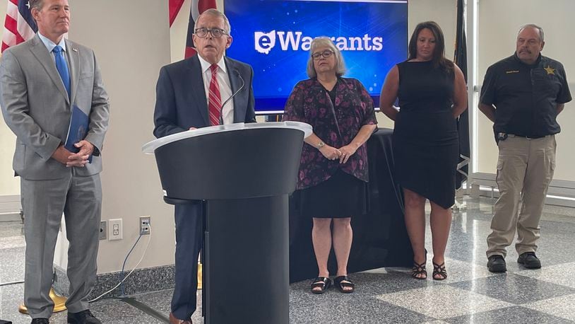 Gov. Mike DeWine on July 6 announced the rollout of eWarrants, an electronic system for uploading criminal warrants and protective orders to state and  national databases. Behind him, left to right, are Lt. Gov. Jon Husted, Meigs County Court of Common Pleas Judge Linda Warner, Meigs County Clerk of Courts Sammi Mugrage and Meigs County Sheriff Keith Wood.