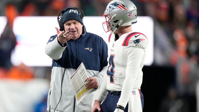 New England Patriots offensive coordinator Bill O'Brien talks to quarterback Bailey Zappe during the first half of an NFL football game against the Denver Broncos, Sunday, Dec. 24, 2023, in Denver. (AP Photo/David Zalubowski)