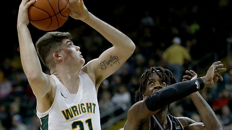Wright State University forward Grant Basile scores two against IUPUI forward Zo Tyson during their Horizon League game at the Nutter Center in Fairborn Sunday, Feb. 16, 2020. Wright State won 106-66. Contributed photo by E.L. Hubbard