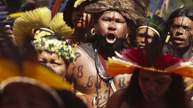 Indigenous people dance during the 20th annual Free Land Indigenous Camp in Brasilia, Brazil, Monday, April 22, 2024. The 7-day event aims to show the unity of Brazil's Indigenous peoples in their fight for the demarcation of their lands and their rights. (AP Photo/Luis Nova)