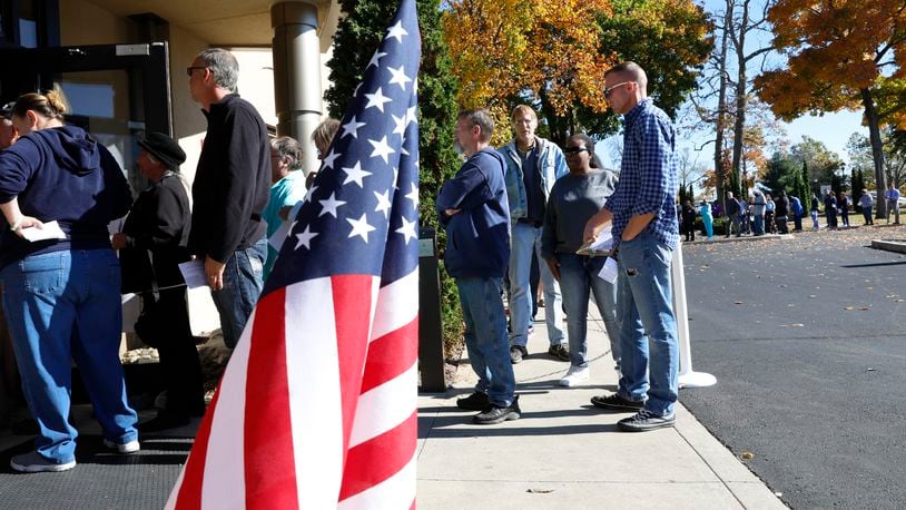 A line of voters stretches out the door and around the parking lot of the Clark County Board of Elections as people wait for over an hour to cast their vote during early voting last year. BILL LACKEY/STAFF