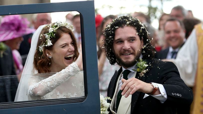 'Game of Thrones' actors Kit Harington and Rose Leslie celebrate as they leave after their wedding ceremony, at Rayne Church, Kirkton of Rayne in Aberdeenshire, Scotland, Saturday June 23, 2018.