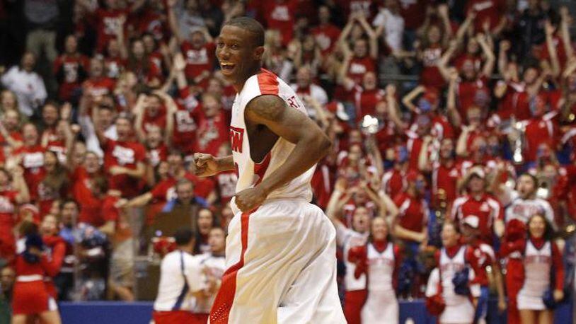 Jordan Sibert smiles as he runs back up court after a game-winning 3-pointer with 1 second left against IPFW on Saturday, Nov. 9, 2013, at UD Arena. David Jablonski/Staff