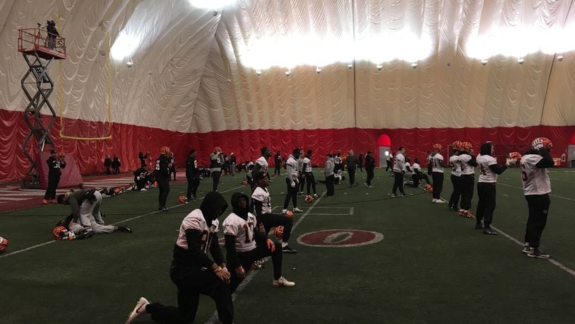 Cincinnati Bengals players stretch prior to the start of Wednesday’s practice at theh University of Cincinnati indoor facility. JAY MORRISON/STAFF