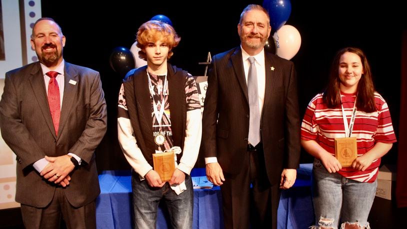 Roosevelt Middle School students Lily Hatton & Corbin Lambert along with Springfield City School District Superintendent Bob Hill and Ohio Attorney General Dave Yost during last year's Do the Write Thing challenge. Contributed/Springfield City School District.