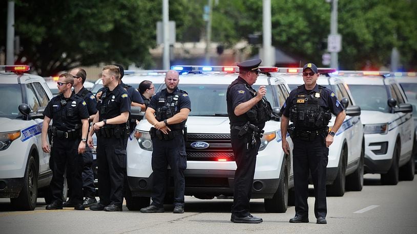 Dayton Police Department wait outside the Dayton Safety building Monday, July 25, 2022, to pay respects to fallen Clark County deputy Matthew Yates. A law enforcement procession escorted the body of the 15-year veteran from Dayton to Springfield. MARSHALL GORBY \STAFF