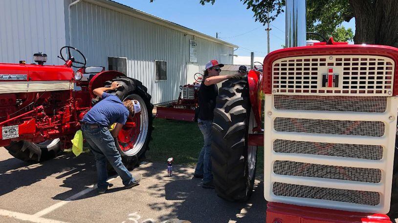 Preparations to display hundreds of vintage International Harvester tractors, trucks and other products went on Tuesday at the Clark County Fairgrounds in anticipation of the Red Power Round Up, an international gathering of IH collectors who will display their items Thursday through Saturday. BRETT TURNER/CONTRIBUTED