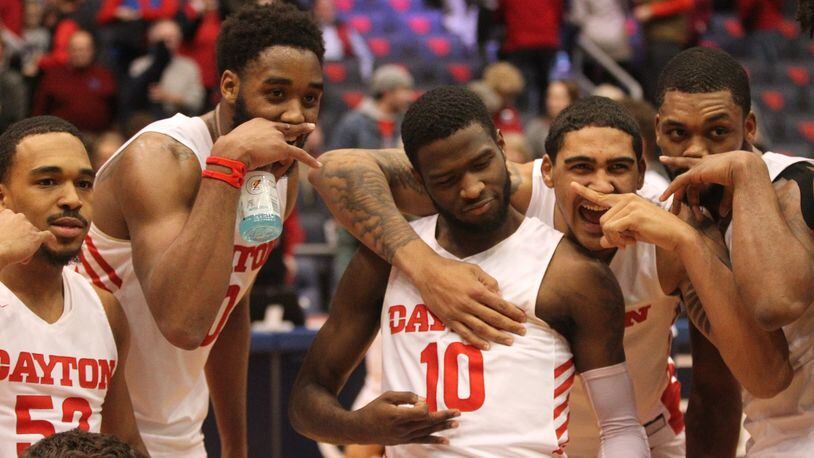 Dayton players pose for a photo after a victory against La Salle on Wednesday, March 6, 2019, at UD Arena. David Jablonski/Staff