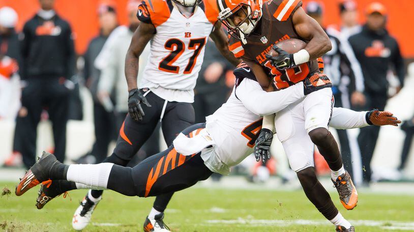 CLEVELAND, OH - DECEMBER 6: Outside linebacker P.J. Dawson #47 of the Cincinnati Bengals tackles Wide Receiver Darius Jennings during the second half at FirstEnergy Stadium on December 6, 2015 in Cleveland, Ohio. The Bengals defeated the Browns 37-3. (Photo by Jason Miller/Getty Images)