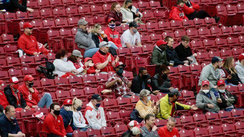 Reds fans cheer during a game against the Diamondbacks on Tuesday, April 20, 2021, at Great American Ball Park in Cincinnati. David Jablonski/Staff