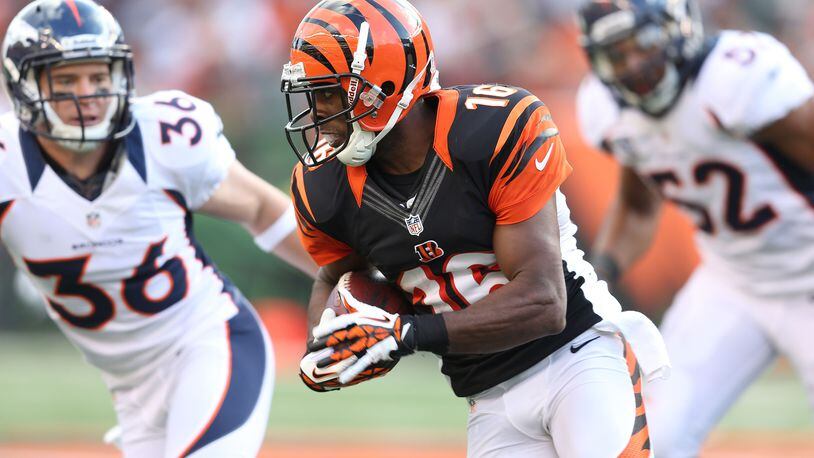 Former Bengals wide receiver Andrew Hawkins is seen here running with the ball against the Broncos at Paul Brown Stadium on November 4, 2012. He retired Tuesday shortly after signing a contract with the Patriots.