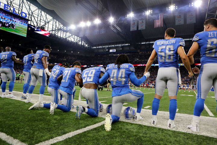 Falcons, Lions link arms during national anthem; singer kneels after performing it